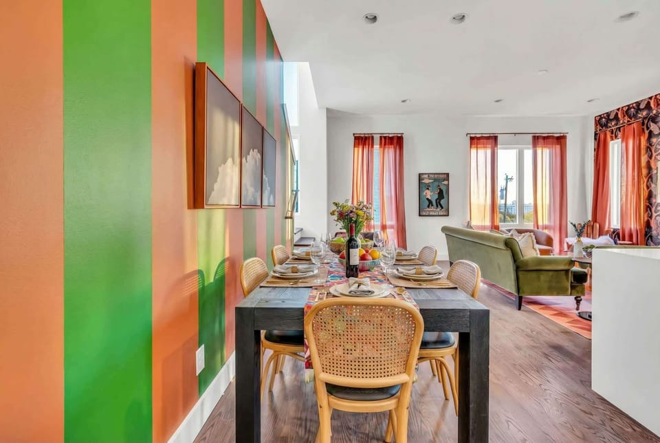 The open dining area brings your whole group together around a table set for celebrations, with bold striped walls and cloud art setting the safari mood in Nashville
