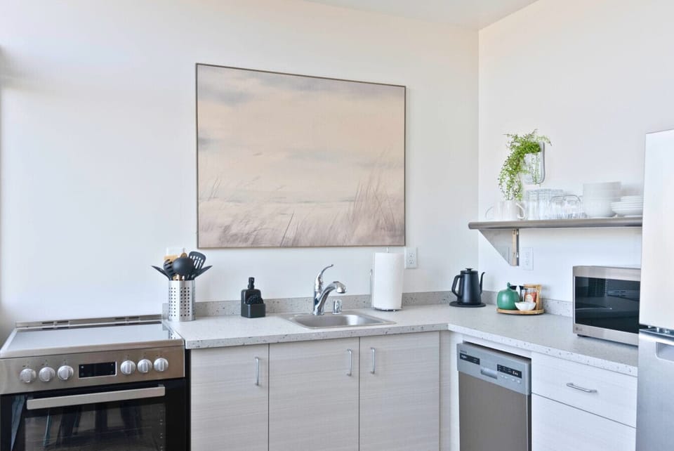 Enjoy cooking in this sleek, modern kitchen with all essentials provided.