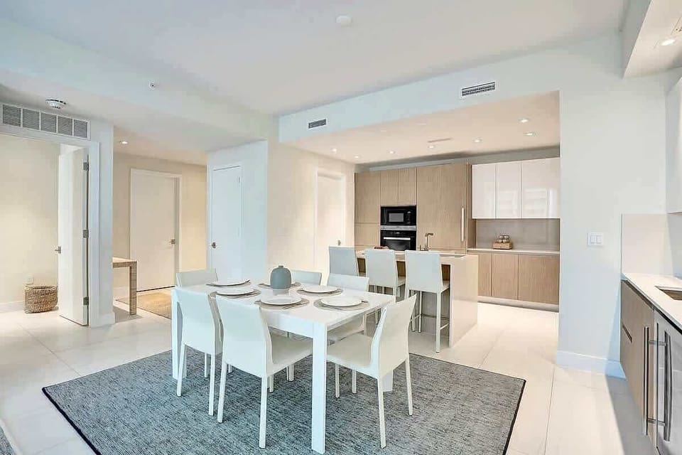 Dining area with six seats and kitchen beyond