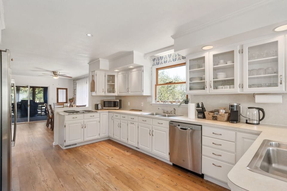 Clean, airy kitchen w/ white cabinetry, ample counter space, & an easy flow into the living areas.