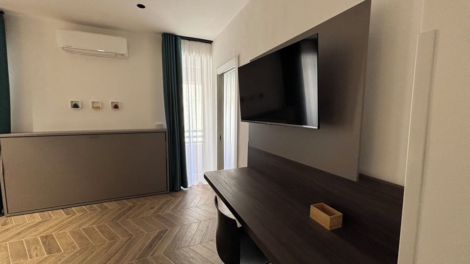 Deluxe Triple Room, Balcony, Partial Sea View | Desk, laptop workspace, blackout drapes, soundproofing