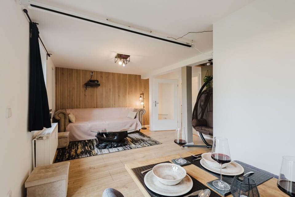 Open-plan dining and living space with projector and unique designer touches.