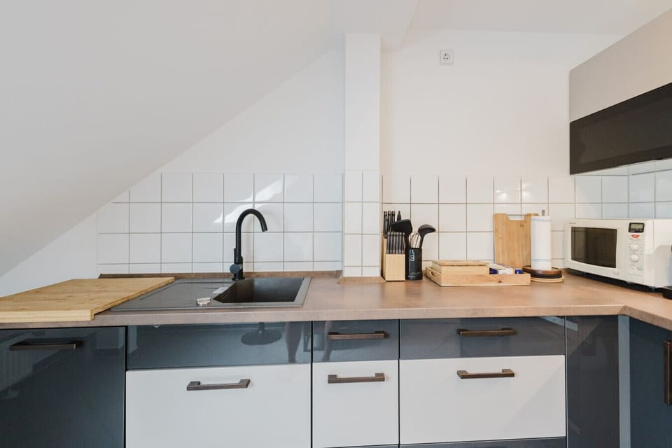 Clean and well-equipped kitchenette with modern appliances.