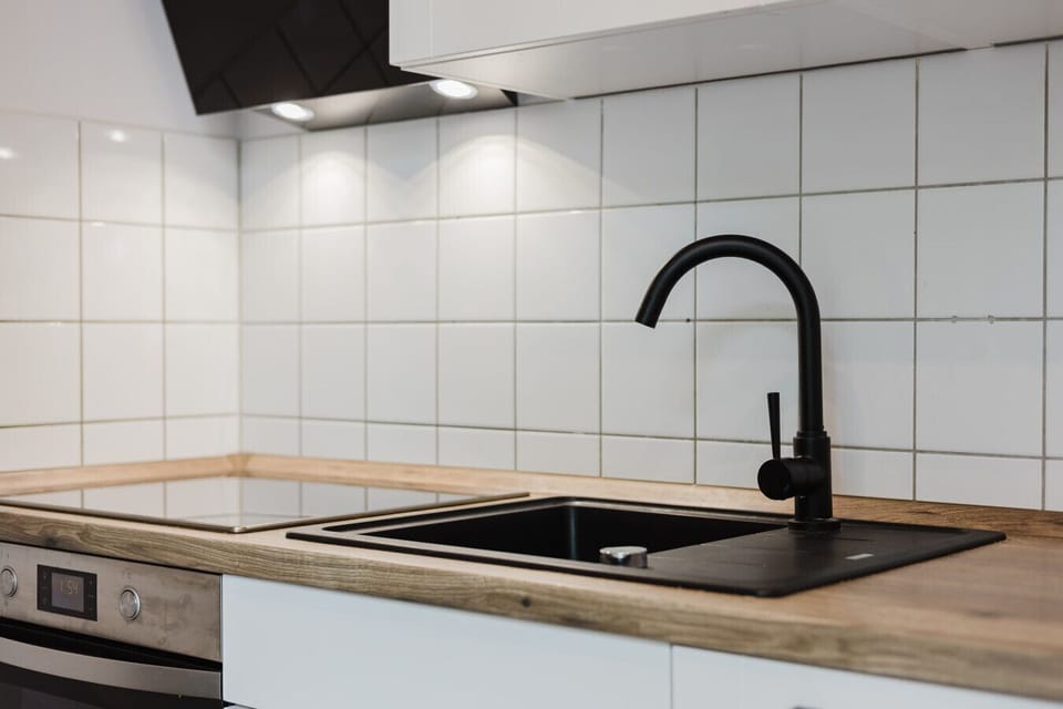 Contemporary cooking area with sleek surfaces and modern fixtures.