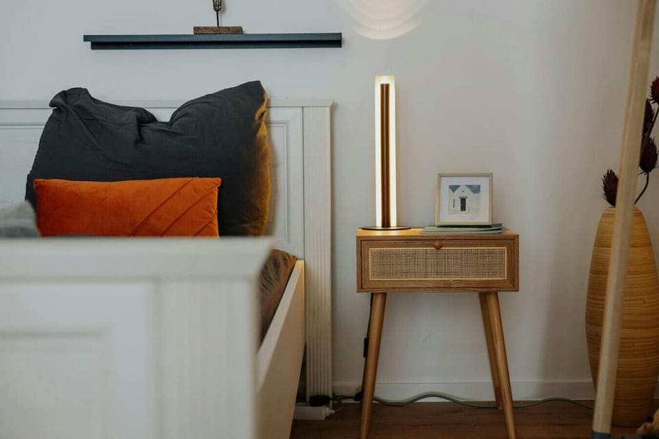 The bed with nightstand and bedside table.