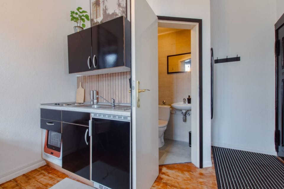 View of the kitchenette and into the bathroom.