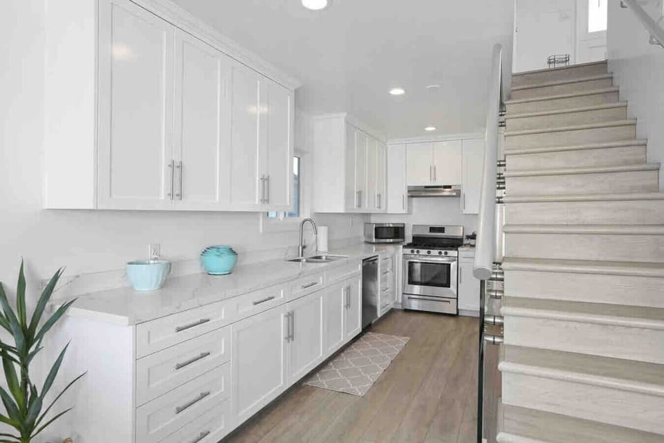 `Fully stocked kitchen with modern appliances, spacious dining table, and everything needed for family meals.`