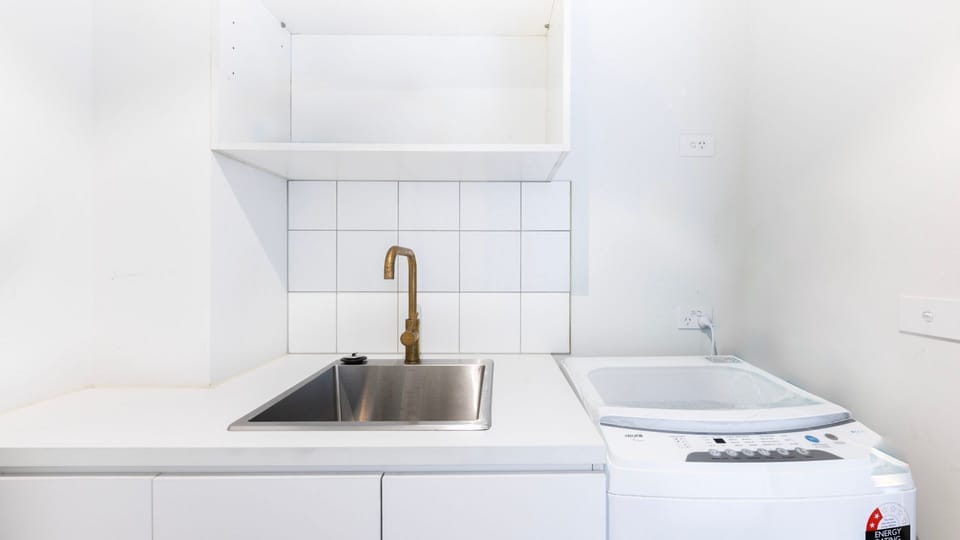 Compact laundry nook with functional modern styling.
