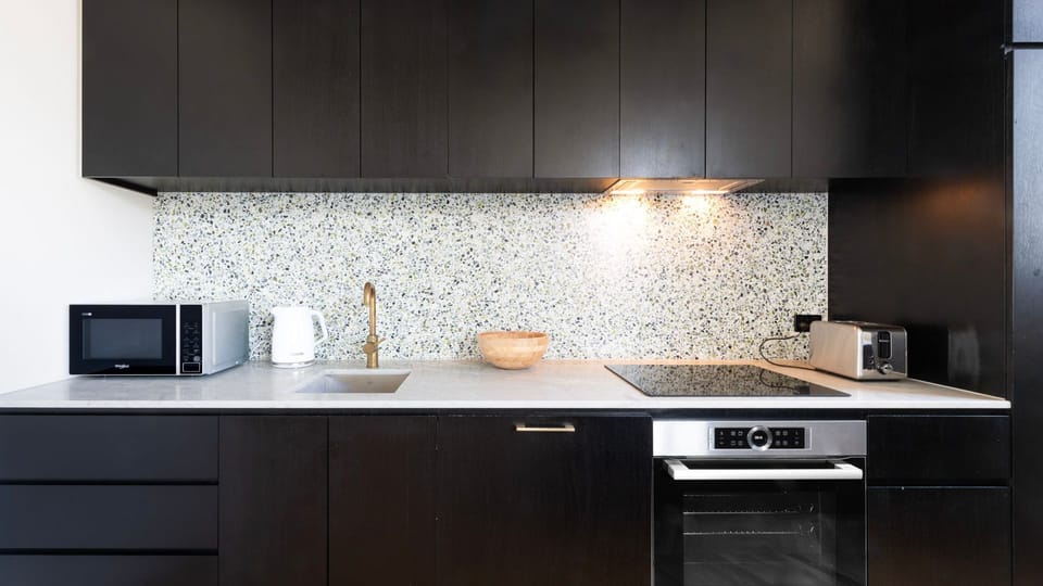 Fully equipped gourmet kitchen with premium appliances and sleek cabinetry.