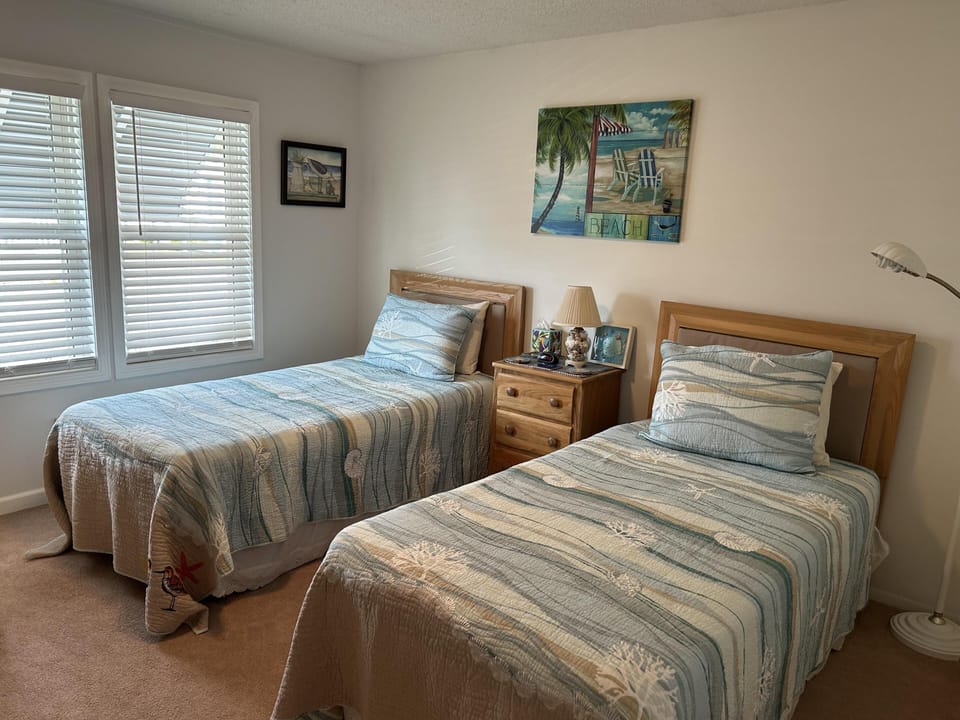 Cozy twin bedroom with soft natural light and calming decor