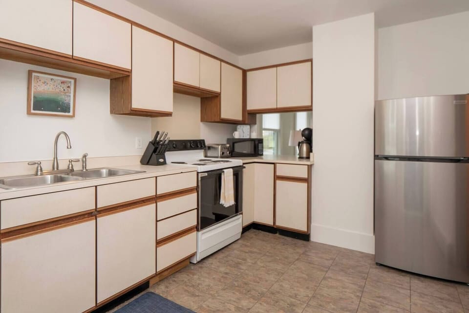 Functional kitchen with stove, frig and sink. Service for 6 people and pots, pans, and spices
