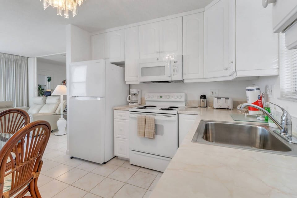 Cookware, dinnerware, kitchen tools and small appliances are provided, including a drip coffee maker.