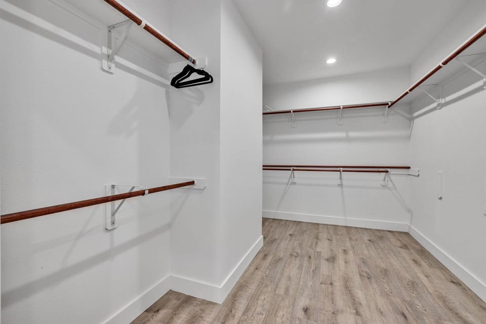 Fully equipped walk-in primary closet.