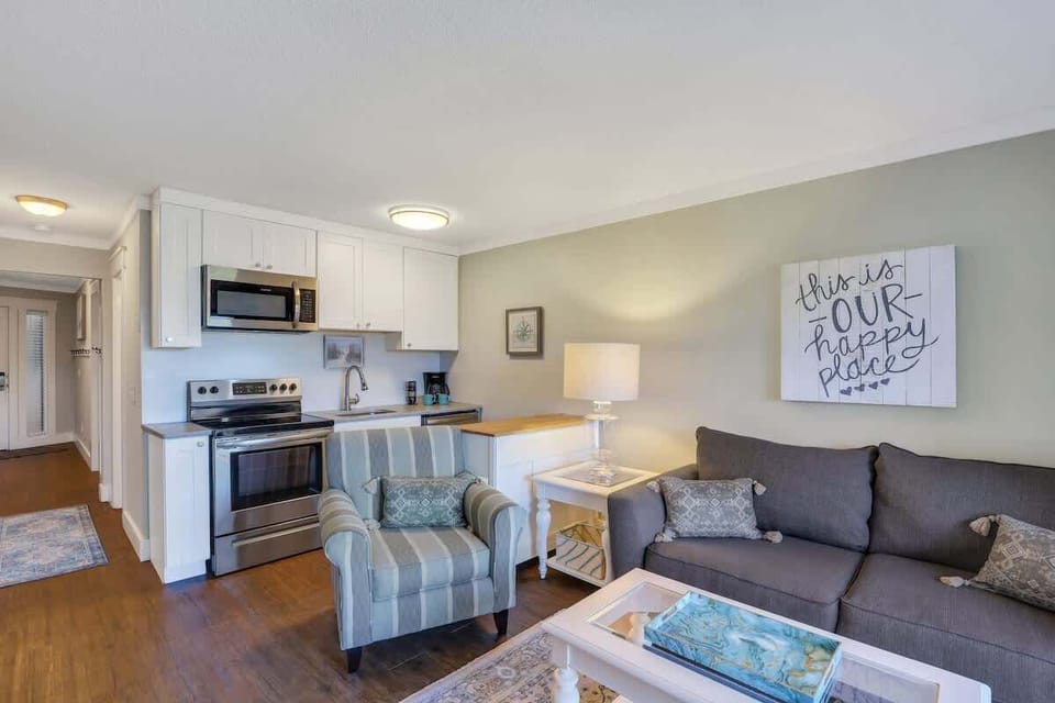 Features a white coffee table set over a decorative area rug.