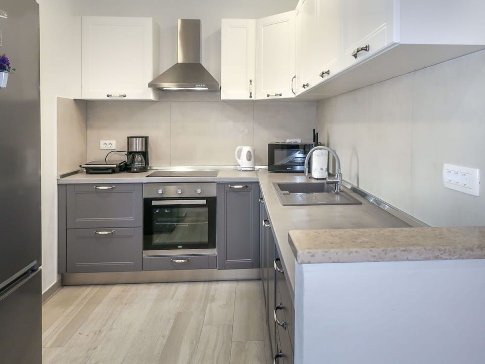 Kitchen Appliance, Kitchen, Countertop, Cabinetry, Furniture, Major Appliance, Kitchen Stove, Interior Design, Flooring, Home Appliance