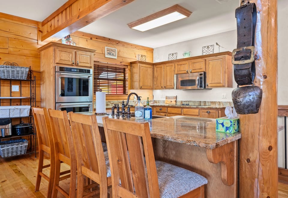 The kitchen island offers extra seating, perfect for a quick breakfast or chatting while dinner is being prepared.