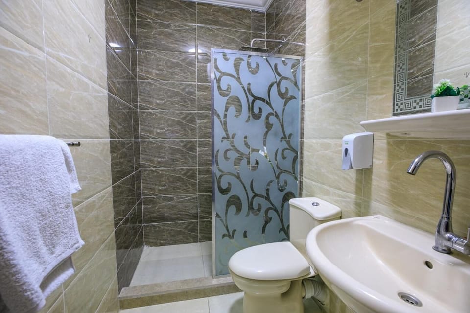 Deluxe Triple Room, City View | Bathroom | Rainfall showerhead, free toiletries, hair dryer, bathrobes