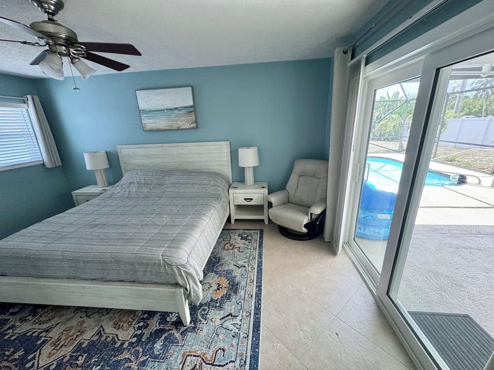 Pool and outdoor patio is accessible directly from sliding door in room.