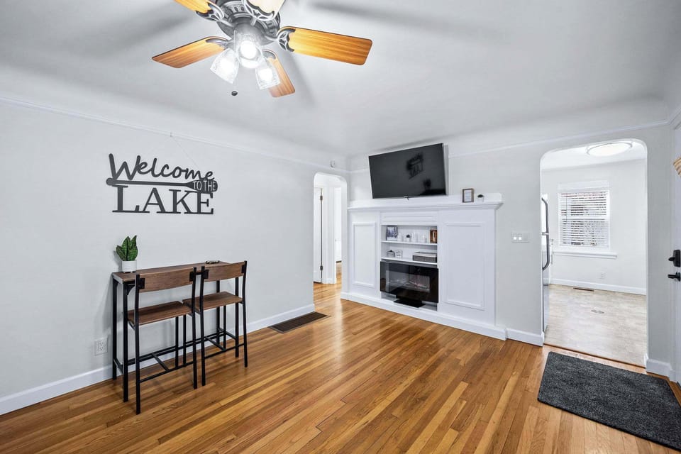 Step into your cozy lake retreat where warm wood floors and a welcoming fireplace create the perfect atmosphere for relaxation.
