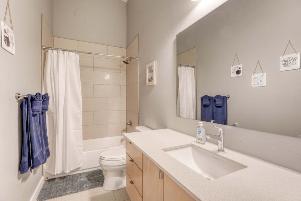 Bright ensuite bathroom with modern vanity, mirror lighting, and room for your toiletries.