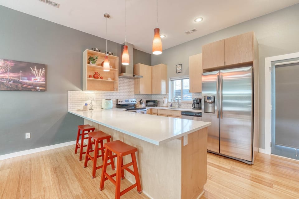 Open‑concept kitchen with stainless appliances, Keurig, and breakfast bar seating—a great spot for dining or working.