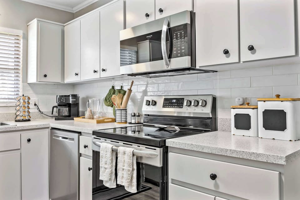 Modern kitchen with stainless steel appliances and white cabinetry
