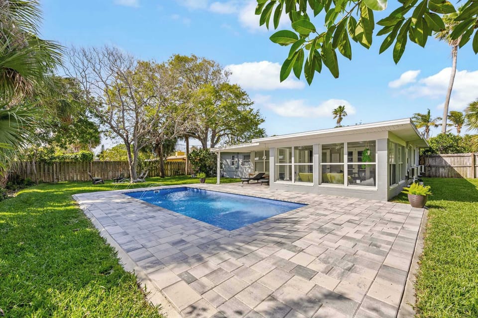 Relax by the private pool in this bright and spacious backyard retreat.