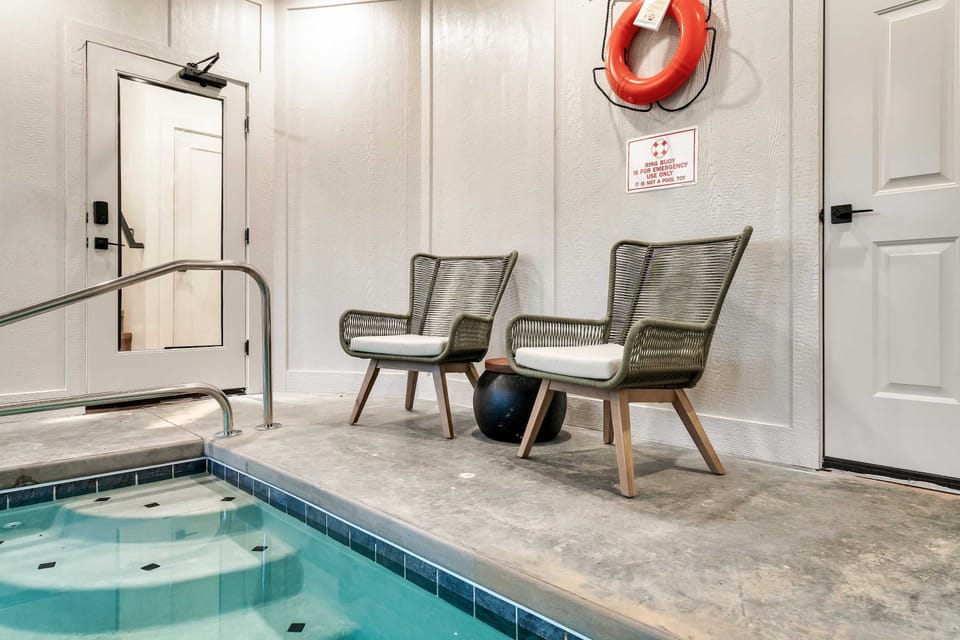 Dive into relaxation with sleek seating and inviting water just steps away!