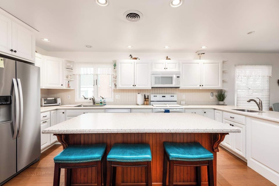 Fully Stocked Kitchen with Large Island and Bar Seating Perfect for Casual Dining and Conversations