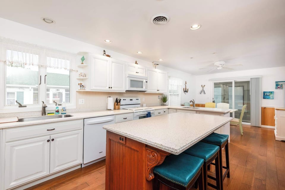 Fully Stocked Kitchen with Large island, Bar seating, Dishwasher, Oven, Microwave, and Sink