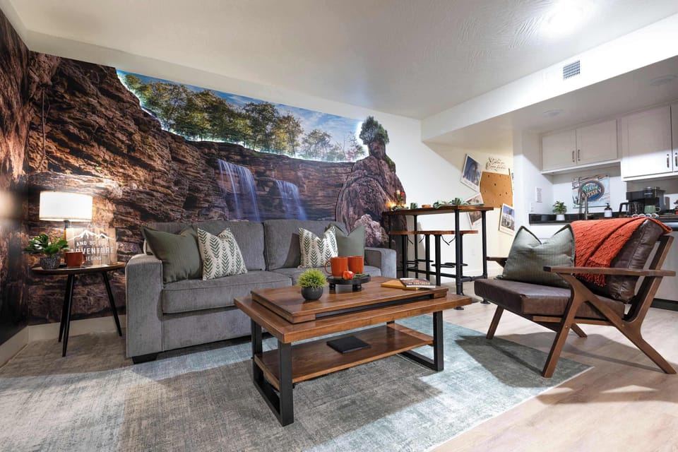 Welcome to Ozark Odyssey, where you'll be greeted by gorgeous, wrap-around artwork in the living room that makes you feel like you're standing at the foot of a majestic waterfall