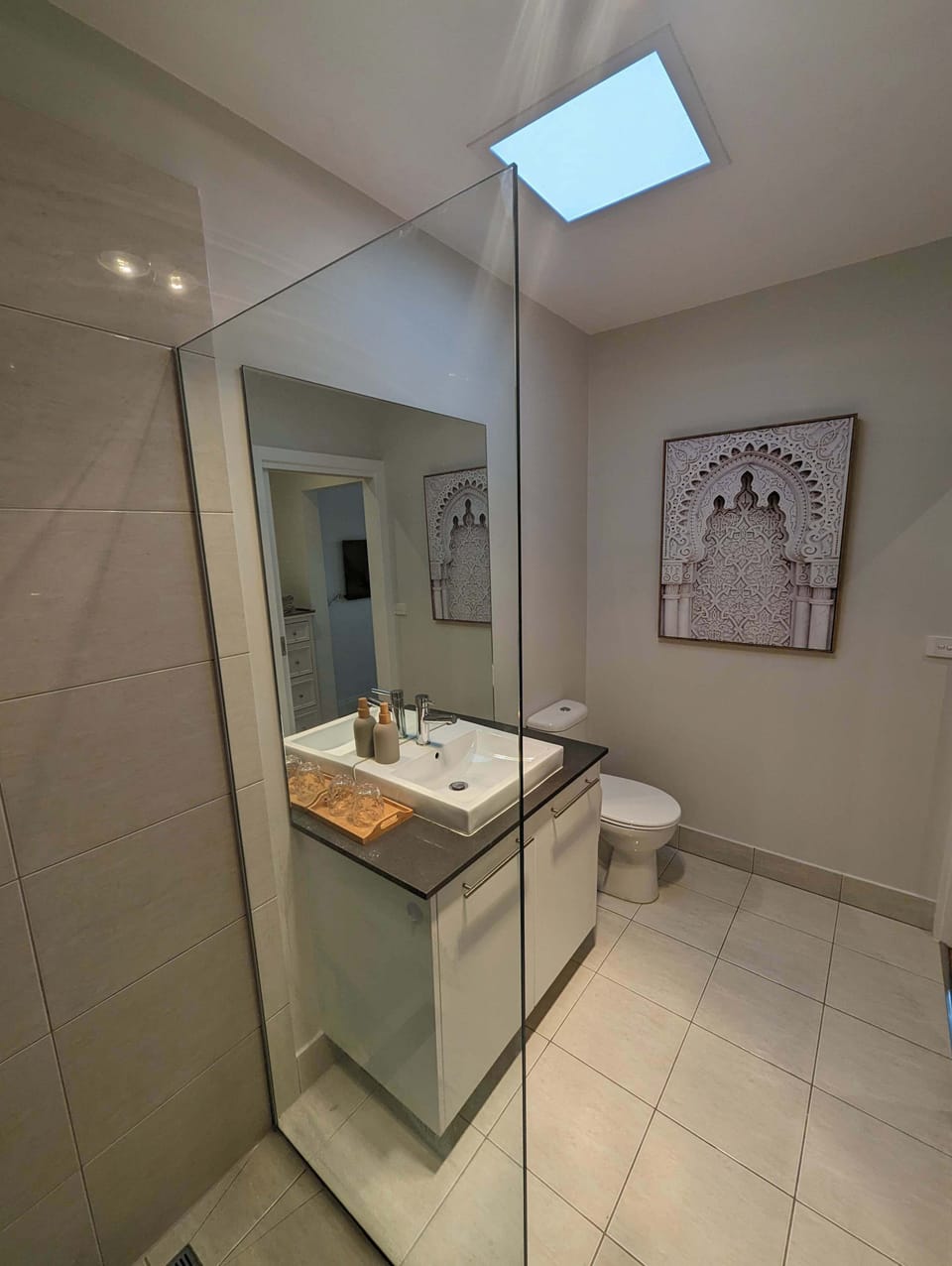 Ensuite bathroom with shower, toilet and bathroom vanity.