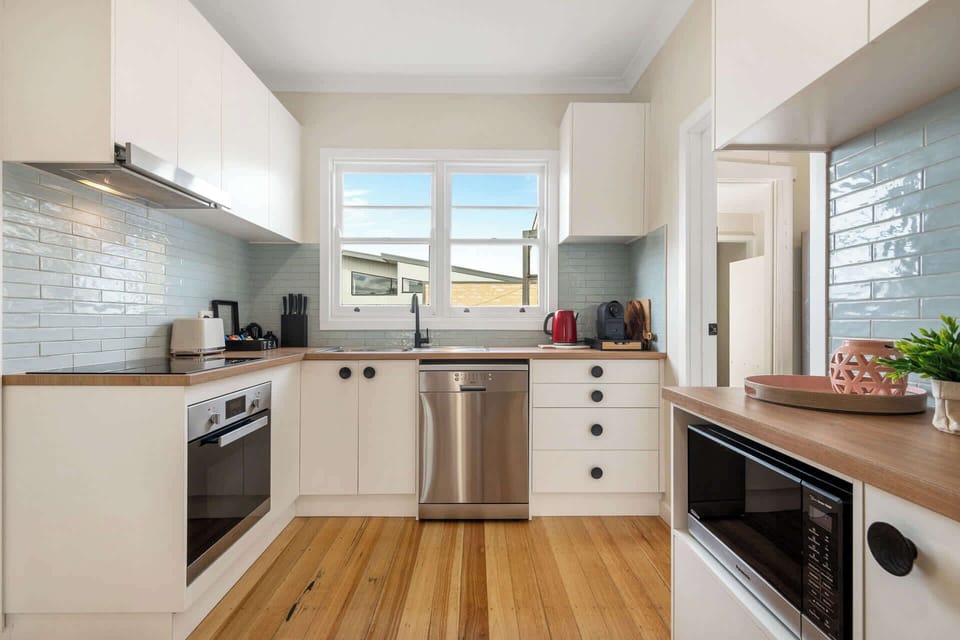 Fully-equipped kitchen with oven, stove, dishwasher, microwave, fridge, coffee pod machine and more. 