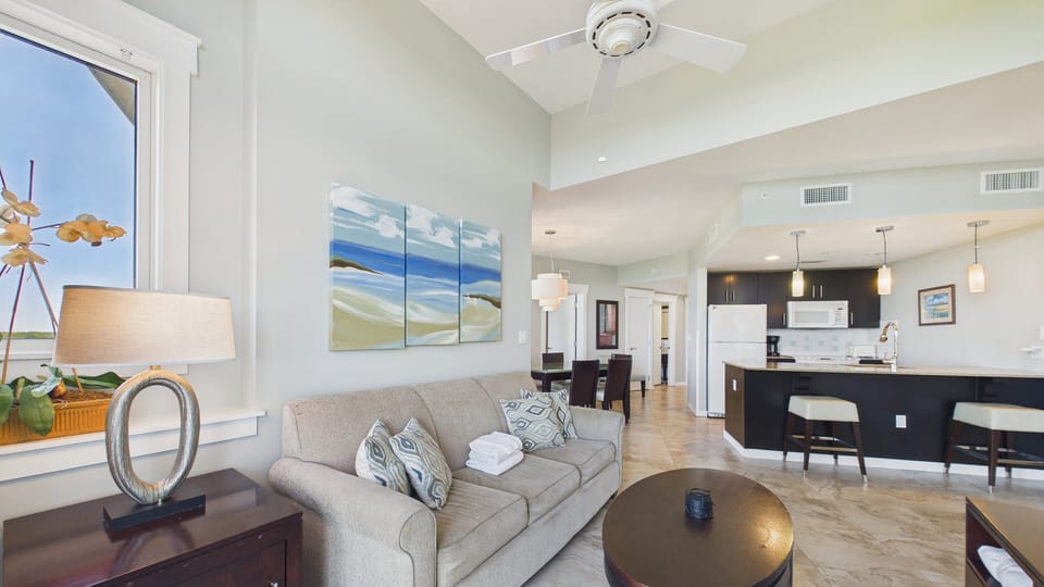 Open concept living area with TV sofa bed and balcony access