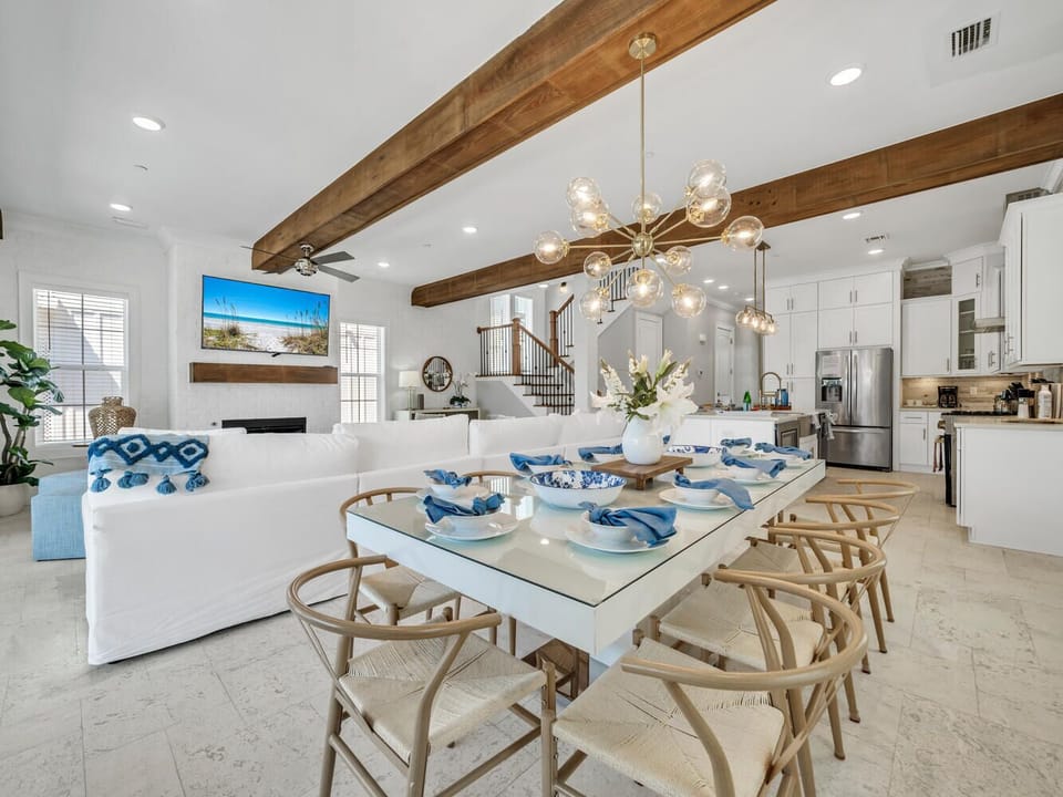 Relax in this stunning open-concept living space where exposed wood beams and coastal blues create your perfect lakeside retreat.