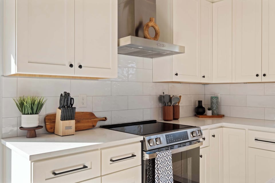 Fully stocked kitchen with coffee gear, pots, pans, and quality appliances.