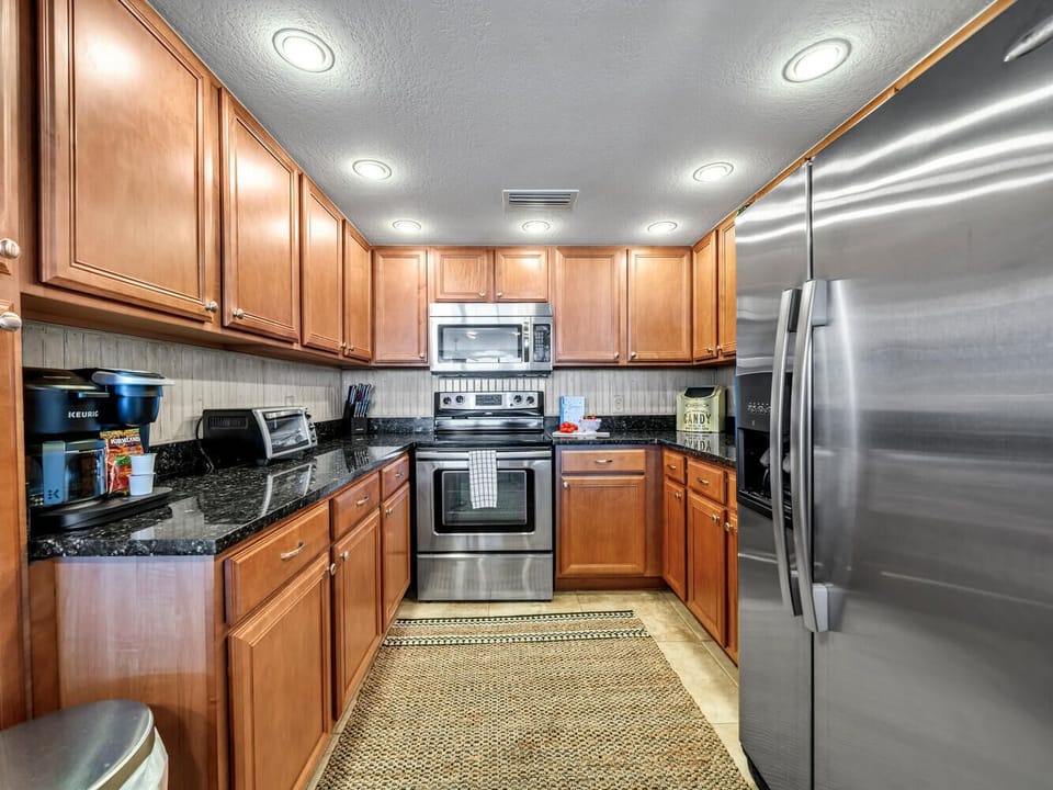 Your fully equipped kitchen features rich wood cabinetry, granite countertops, and stainless steel appliances for all your culinary adventures.