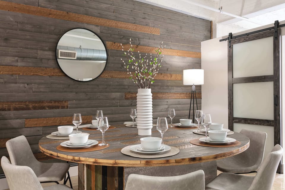Dining area with wood panel backdrop and decorative touches