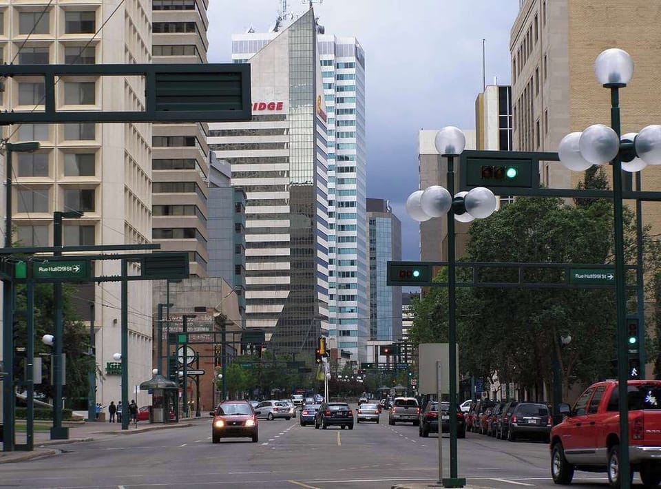 Stroll along the picturesque Jasper Avenue, featuring wide sidewalks, lush greenery, and a welcoming ambiance perfect for day or night outings.