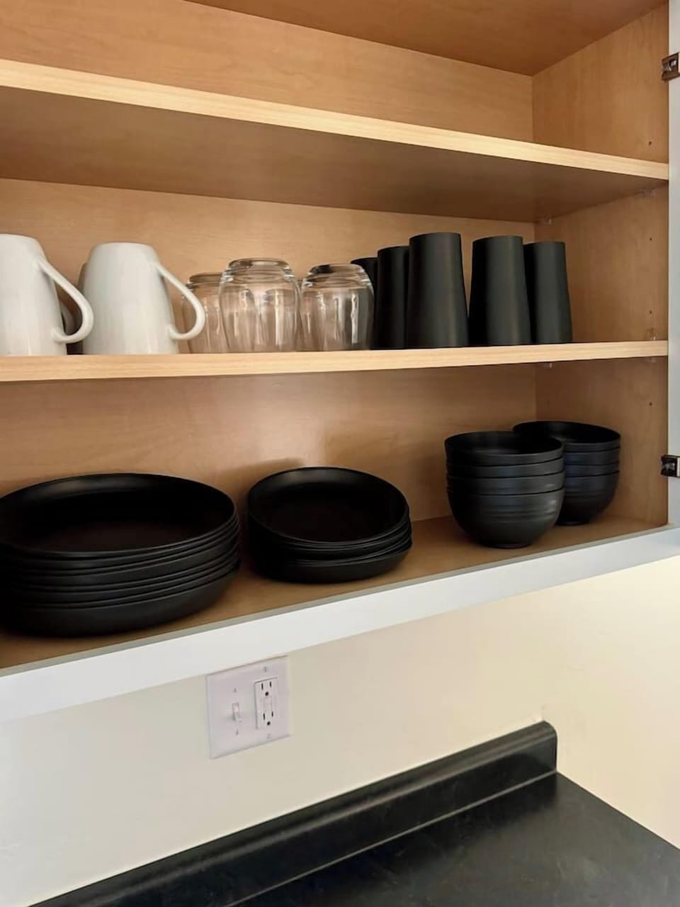 Fully stocked kitchen with plates, bowls, mugs, and glassware for your stay