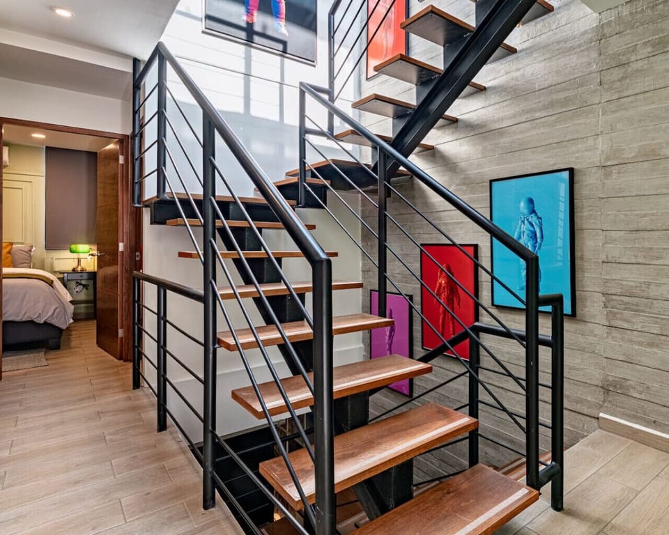 Staircase with contemporary design leading to higher floors and additional spaces