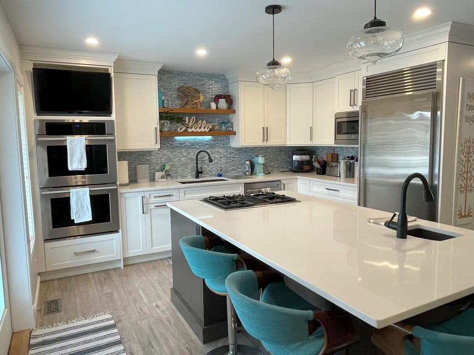 Kitchen features large wall fridge