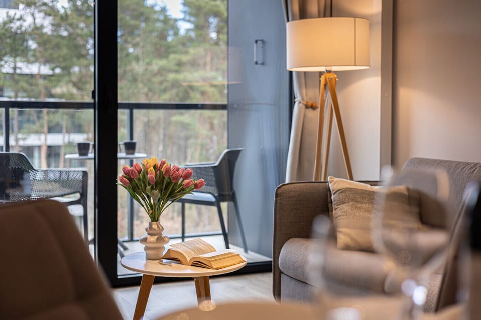 A stylish table with an open book, gently illuminated by a corner lamp. The perfect spot for a peaceful evening of reading.