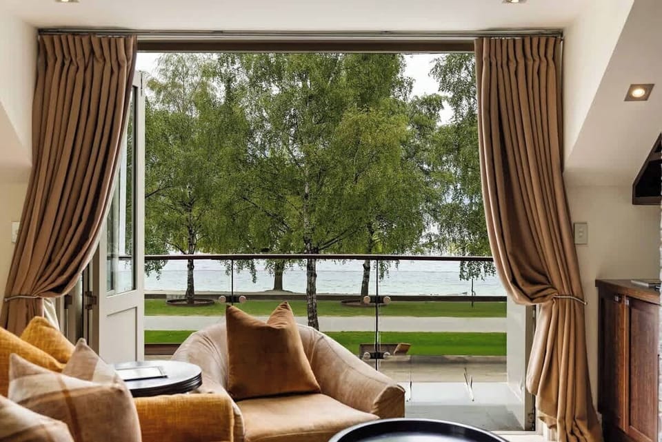 Bright & Airy with Stunning Scenery – The spacious lounge is bathed in natural light, leading to a private balcony where you can soak in lake and mountain views.