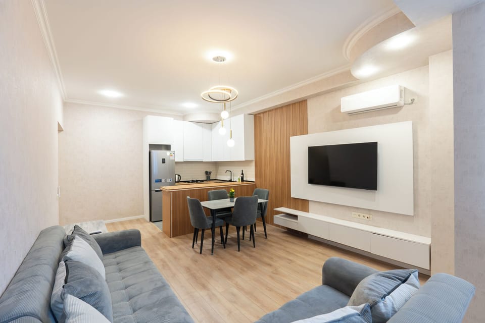 Deluxe Apartment, Balcony, City View | Living area | 43-inch TV with cable channels