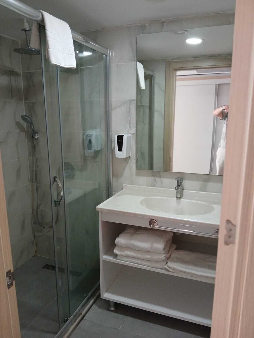 Shower, hair dryer, slippers, towels