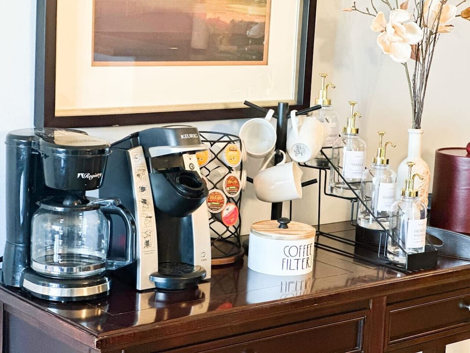 Kickstart your mornings with a curated coffee bar featuring a variety of brews and syrups for a personalized touch.