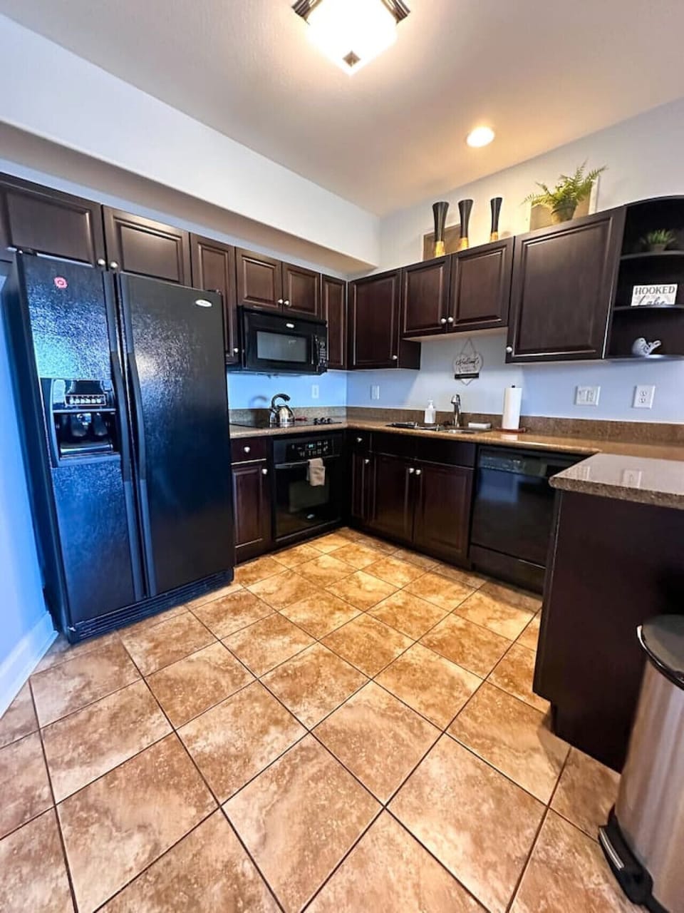 Spacious countertops and dark wood cabinets make this kitchen both functional and stylish—perfect for creating delicious meals.