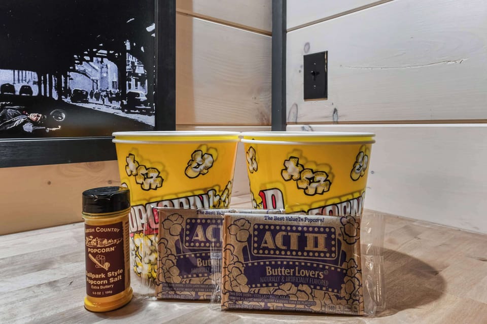 Popcorn buckets with butter lovers microwave popcorn and extra buttery popcorn salt for a cozy movie night.