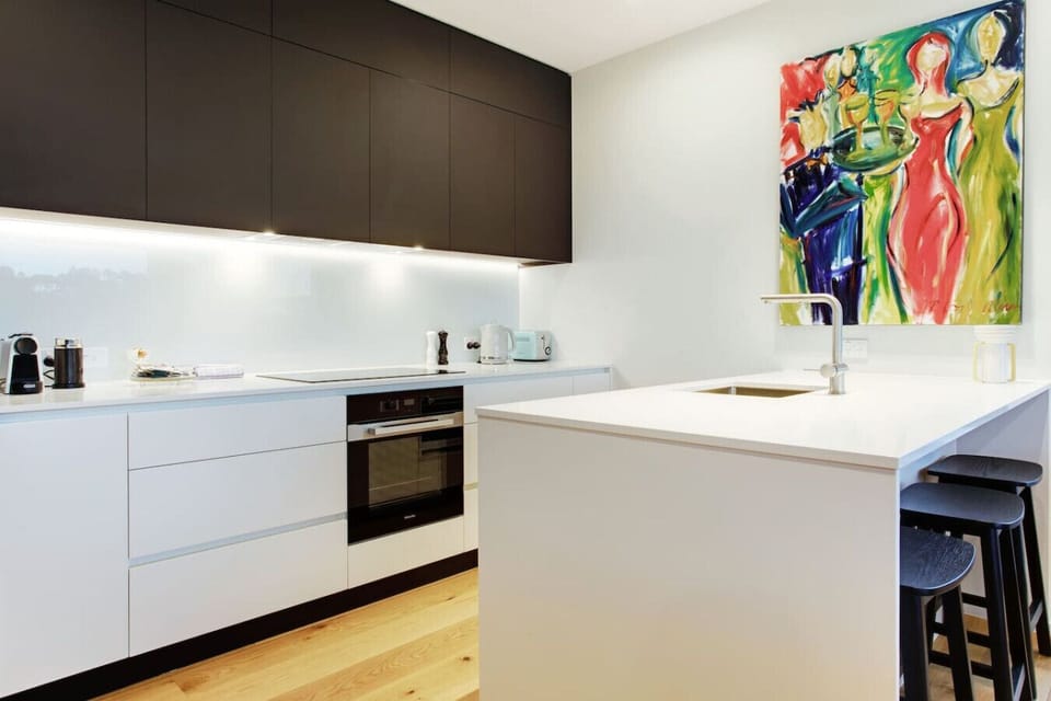 The kitchen has a cooktop, oven, microwave, toaster, kettle and dishwasher.